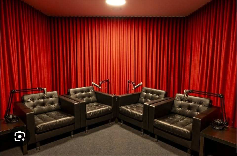 Podcast studio with microphones and four chairs